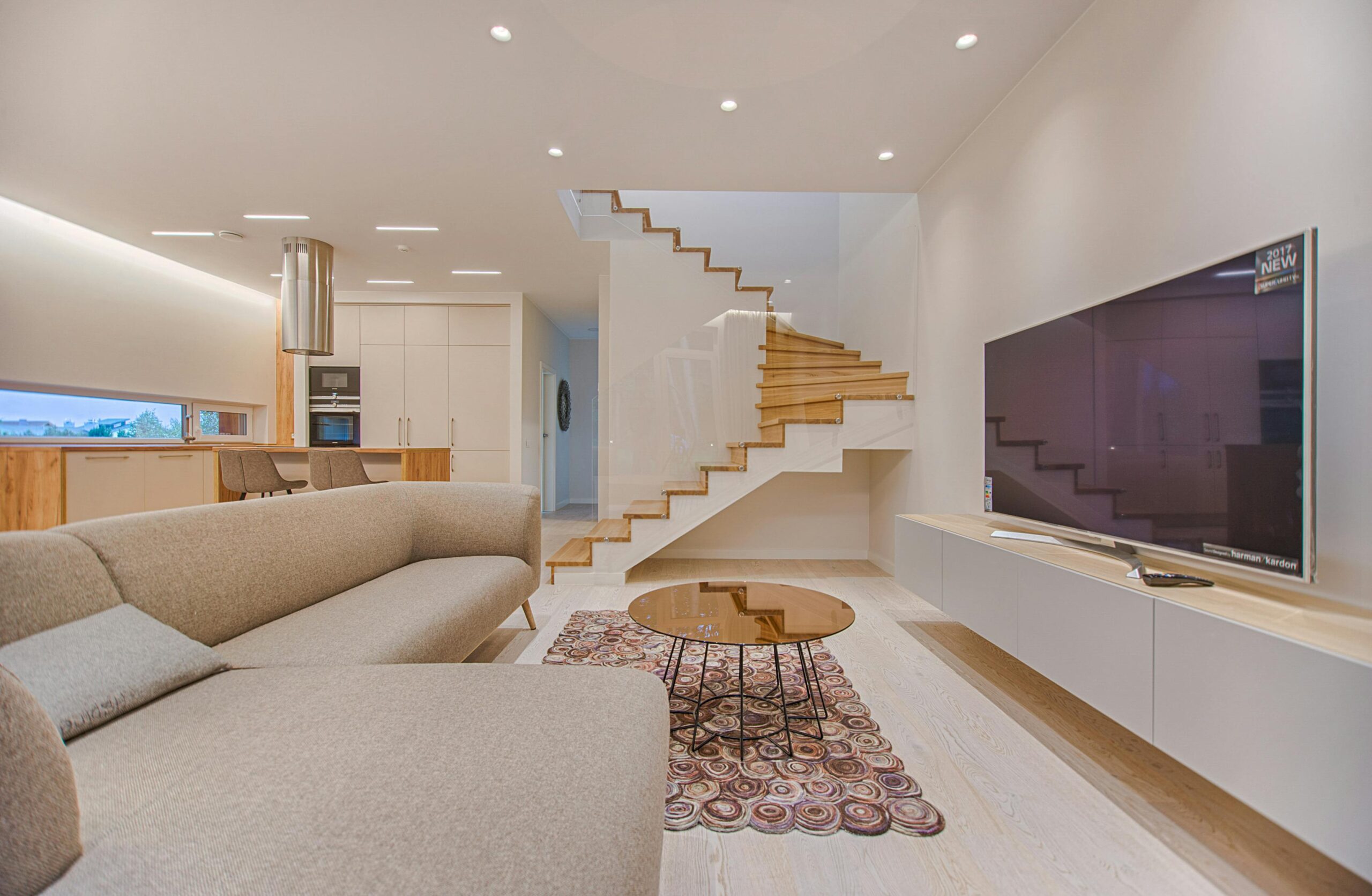 pexels-photo-1571459-1571459 Spacious modern living room featuring stairs, a TV, and sleek furniture design.